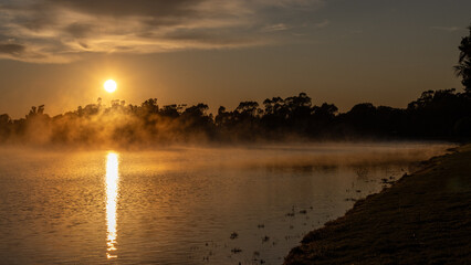 A misty sunrise over Gum Bend Lake, Condobolin, NSW, Australia