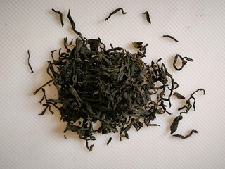 black tea loose dry leaves brew on white background, drink plant nature