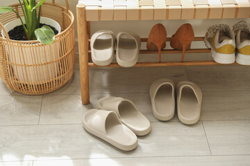 Sticker - Many pairs of slippers and other shoes in entryway at home