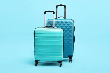 Sticker - Different bright suitcases on light blue background