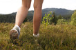 © New Africa - Woman hiking in mountains, closeup. Active travel