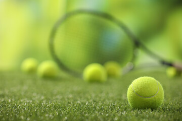 Poster - Bright tennis ball on green artificial grass