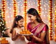 © MdRakibul - Happy young indian girls wearing traditional cloths having laddu or laddoo sweet celebration diwali festival together isolated on studio background.Female friends or sisters have fun together