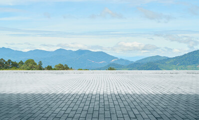 Wall Mural - empty brick floor with mountain view under blue sky