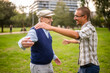 © djoronimo - Happy grandfather and grandson are hugging and embracing in park.