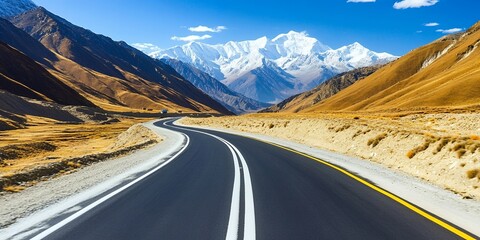 Poster - A winding road through a mountain pass with a snowy peak in the distance.