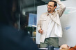 © Jacob Lund - Happy entrepreneur having a discussion with his business team in a boardroom meeting
