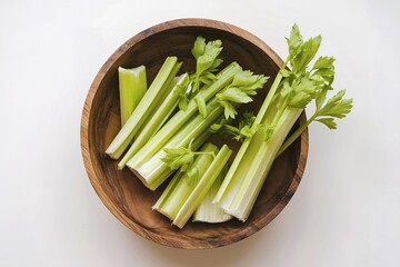 Wall Mural - several pieces of celery in a wooden bowl.