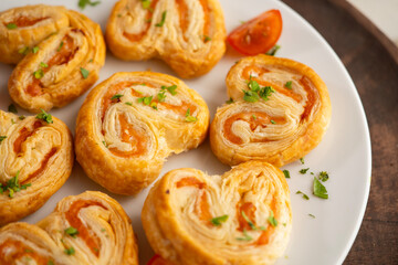 Puff pastry filled with salmon and cheese. Top view table with  decoration.