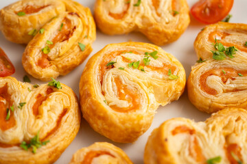 Puff pastry filled with salmon and cheese. Top view table with  decoration.