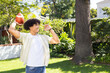 © Wavebreak Media - Throwing football, man enjoying outdoor activity in backyard garden with trees