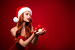 © Beauty Hero - Photo of tempting chic lady hold christmas tree toys decoration look advertise wear santa claus hat dress