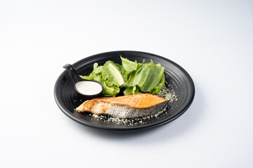 Fresh Salmon with Greens and Dressing on Plate