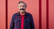 © Arceli - Confident elderly Hispanic man with mustache wearing flannel on plain red background
