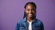© Arceli - Smiling African American teenage girl with braids wearing denim jacket on plain purple background