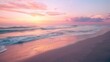 © Asayamrad - The soft morning light paints a tranquil beach scene with gentle waves and a sky of pink, orange, and purple.