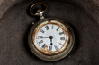 © Eduardo Estellez - Antique pocket watch at the bottom of an old ceramic container.