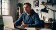 © Arceli - Focused middleaged Caucasian man wearing a hoodie in a home office