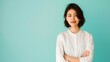 © Qstock - Confident Young Woman in White Shirt Against Mint Green Background - Business Professional Portrait Photograph