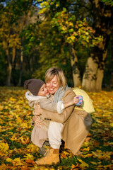 A serene autumn day where a mother and her little girl share a tender embrace