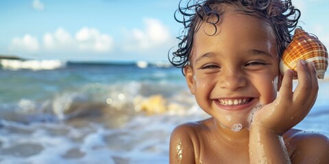 A happy child with wet hair and a big smile, holding a seashell up to their ear to listen to the ocean