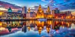 © Danicha - Stunning Liverpool City Skyline at Dusk with Illuminated Buildings and Reflections on Water Surface