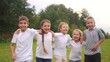 © ibragimova - a group of children jumping in the park on the grass embracing. happy family childhood dream concept. little kids jump hugging each other by the shoulders. lifestyle children smiling and laughing