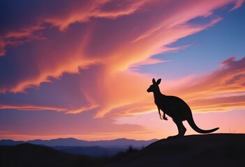 A kangaroo silhouette in a vibrant sunset landscape with mountains, clouds, and a flying bird