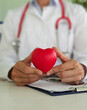 © Nadzeya - Female doctor holding red toy heart in her hands closeup. Internal organ transplant concept