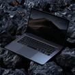 © Dariya - Realistic and mystic photography of laptop with blank sceen placed on raw black rocks, Super clean and sharp, dystopic