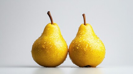 Two yellow pears with a wet surface