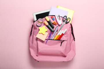 Sticker - Backpack and different school stationery on pink background, top view