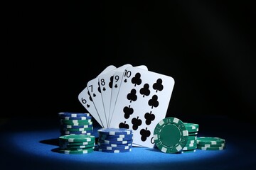 Poster - Poker chips and playing cards on blue table