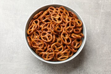 Wall Mural - Delicious pretzel crackers on light table, top view