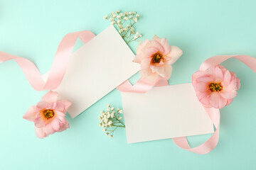 Poster - Floral composition with blank cards, flowers and ribbon on turquoise background, flat lay