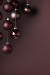 Wall Mural - Christmas vertical background. Bronze and chocolate Christmas ornaments on a dark brown background with copy space.
