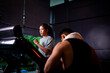 © SKW - Asian man and woman working out, one is a trainer, the other is an exerciser