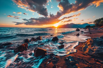 Sun setting over a rocky beach with crashing waves