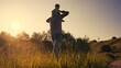 © ibragimova - father carries a little son on his shoulders and walks on the grass in the park. happy family childhood dream concept. a small child sits on the shoulders of his dad man walking lifestyle in field