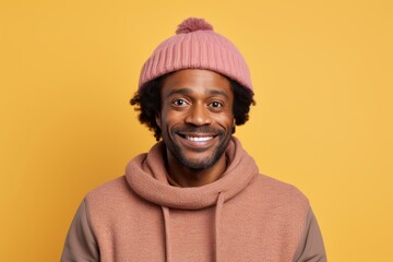 Poster - Portrait of a content afro-american man in his 40s dressed in a warm ski hat over pastel or soft colors background