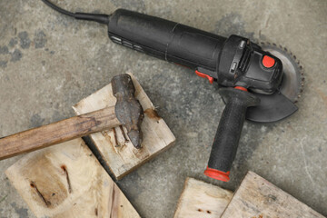 Poster - Angle grinder, hammer and wooden planks on asphalt outdoors, top view