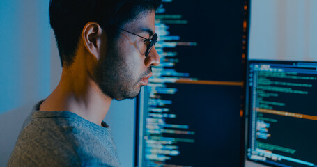 Closeup young adult Asia male freelance typing write prompt AI bot IT app smart program nomad, video game, terminal with coding language, designer, big data center on desktop computer in night office.