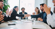 © ihorvsn - Ending of team meeting in business company. People in official clothing. Everyone shaking hands and clapping. Positive ending to discussion. Celebrating positive development. Concept of success.