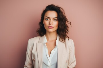 Wall Mural - Portrait of a glad woman in her 20s dressed in a stylish blazer on pastel or soft colors background