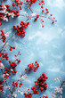 © LanaUst - Bright red berries contrast beautifully against a light blue background, creating a vibrant winter scene with snow accents.