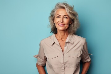 portrait of a satisfied woman in her 50s sporting a vented fishing shirt over minimalist or empty ro
