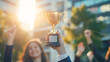 © Dina Photo Stories - business woman in suit holding a golden trophy cup in hand, celebrating success, victory, office team applause outdoors. employee appreciation day. awarding the best employee. Close up, faceless