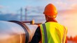 © JP STUDIO LAB - Worker in high-visibility vest inspecting an industrial pipeline, modern construction environment with safety equipment in focus