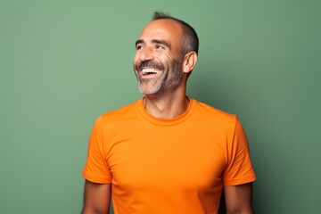 Wall Mural - Portrait of a cheerful man in his 40s sporting a breathable mesh jersey in solid color backdrop