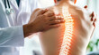 © Dina Photo Stories - Chiropractor examining patient with back pain in clinic. Physiotherapist working examining treating injured back of male patient with spine x-ray visualization, Rehabilitation therapy. spinal health